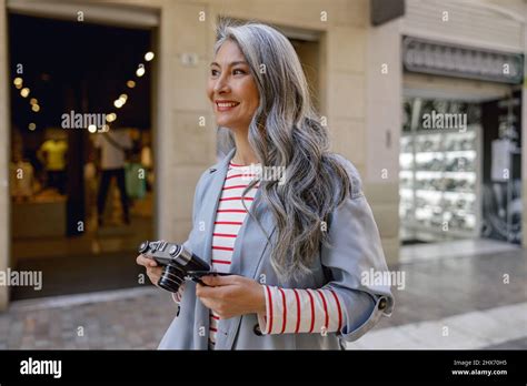 Busy Mature Lady Taking Stroll Through City Stock Photo Alamy