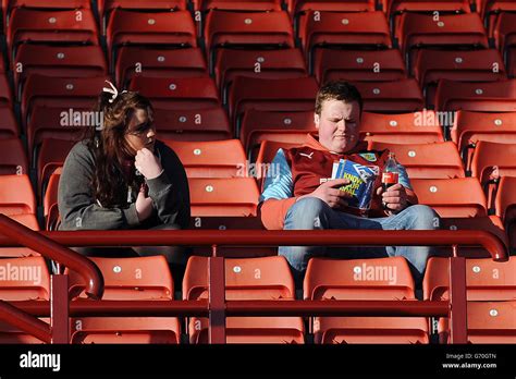 Burnley Fans In The Stands Read The Match Programme Hi Res Stock