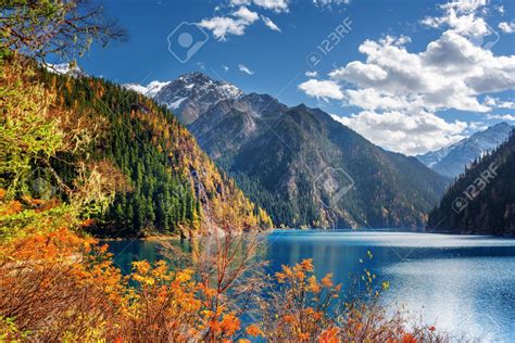 Fantastic view of the Long Lake among mountains and colorful fall woods in Jiuzhaigou nature ...