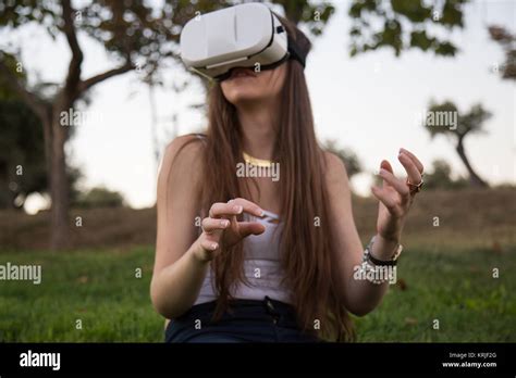 Smiling Brunette Having Fun While Using Glasses Of Virtual Reality In Park Stock Photo Alamy