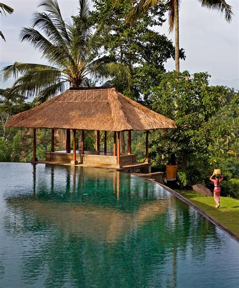 A Gazebo Sitting On Top Of A Lush Green Field Next To A Pool Surrounded