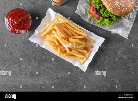 Paper Container With Yummy French Fries On Table Stock Photo Alamy