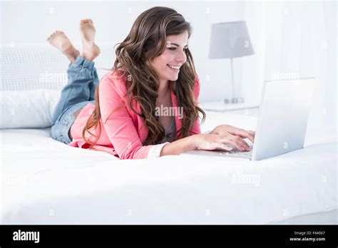 Happy Brunette Using Her Laptop Stock Photo Alamy