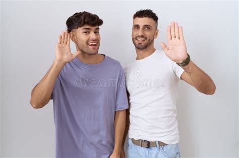 Homosexual Gay Couple Standing Over White Background Waiving Saying