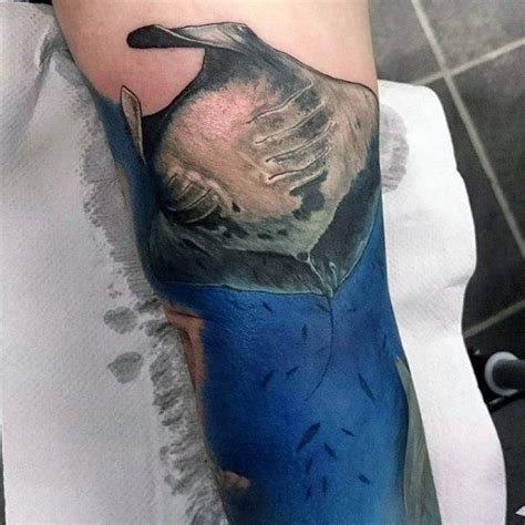 A Person With A Bird Tattoo On Their Arm