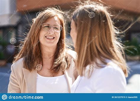 Mother And Daughter Smiling Confident Standing Together At Street Stock