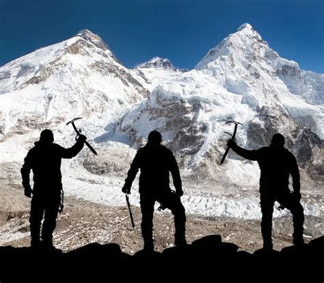 Mount Everest From Kala Patthar And Silhouette Of Men Stock Photo