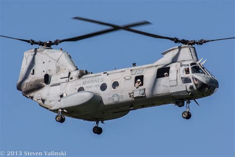 An Army Helicopter Flying In The Sky With Its Landing Gear Down