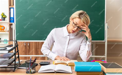 Free Photo Concentrated Young Blonde Female Teacher Wearing Glasses