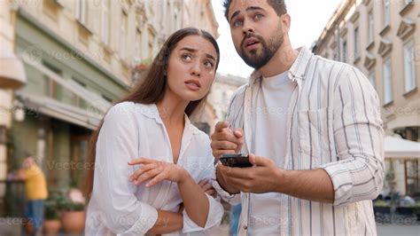 Couple Caucasian man woman using mobile phone smartphone internet maps