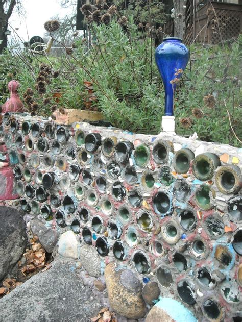 Re-used bottles as garden wall | Bottle garden, Wine bottle garden, Herb garden wall