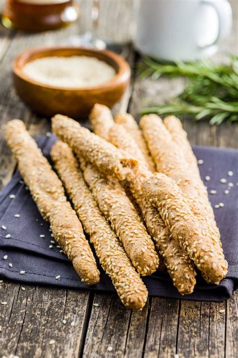 Italian Grissini Bread Sticks With Sesame Seeds On Wooden Kitchen Table