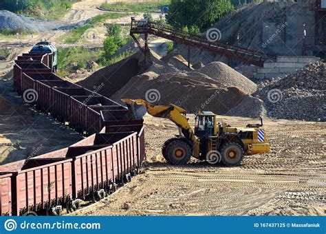 Large Heavy Front End Loader Loading Sand It To The Freight Train