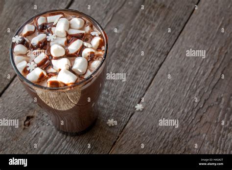 Winter Hot Cocoa With Marshmallows Chocolate Syrup Sugar Snowflakes In A Tall Glass On A