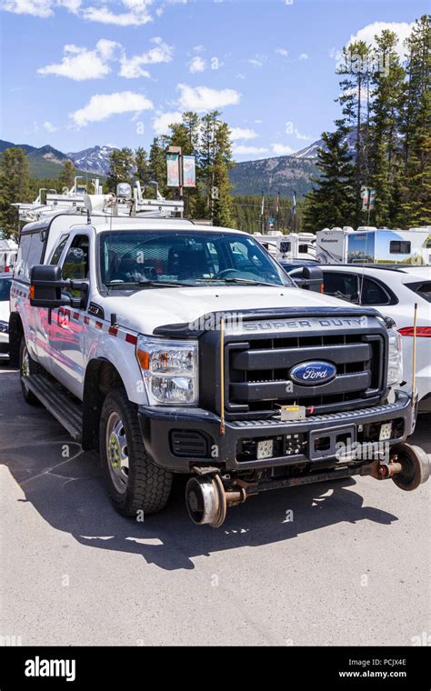 Maintenance Truck Adapted To Also Run On Railway Lines In A Car Park In