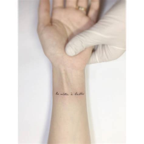 La Vita é Bella Lettering Tattoo Located On The