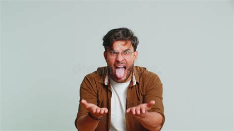 Cheerful Funny Bully Indian Man Showing Tongue Making Silly Faces