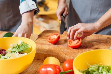 Premium Photo Female Hands Cutting Vegetables For Salad In The Kitchen