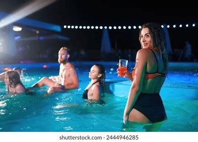 Pretty Woman Bikini Drinking Cocktail Hanging Stock Photo