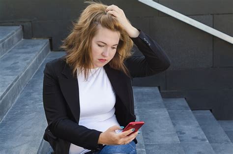 Premium Photo Upset Woman With A Phone In Her Hand Get A Bad News Reads A Message Clutches