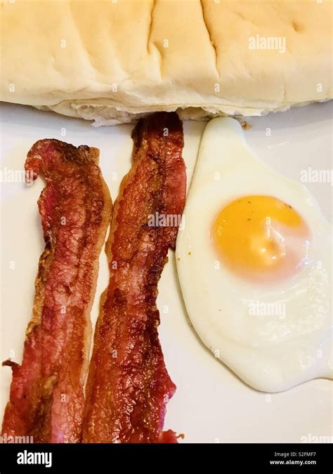 Streaky Bacon Fried Egg And White Baguette Stock Photo Alamy