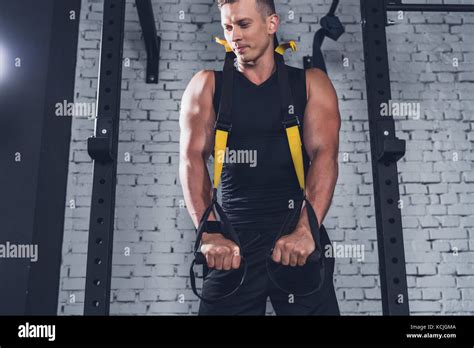 Man Exercising With Trx Gym Equipment Stock Photo Alamy
