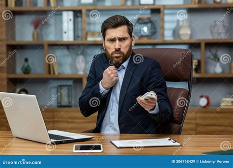 Focused Mature Businessman In Suit Managing Tasks In A Cluttered Home