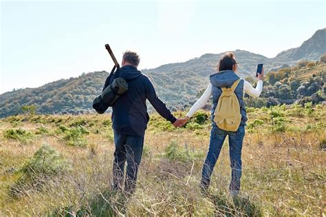 Vista Traseira Do Casal De M Os Dadas Enquanto Caminhava No Prado Rural