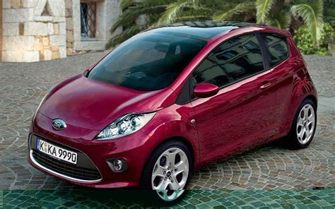 Download Compact Car on the Road Wallpaper | Wallpapers.com 