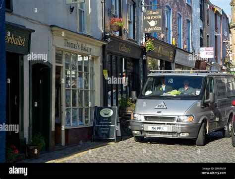 Traffic On Market Street Ulverston Cumbria England Uk Stock Photo