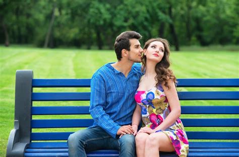 Premium Photo Young Couple Sitting Apart On The Bench In The Park