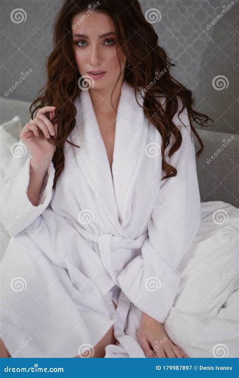 Beautiful Brunette In White Robe Sitting On The Bed Stock Image Image