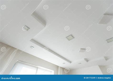 Classic White Glossy Ceiling With Recessed Spotlights Stock Image