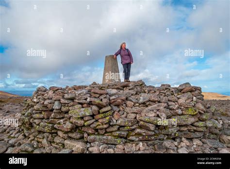 Walker at the trig point at the summit of the mountain Ben Macdui, the 2nd highest peak in the ...