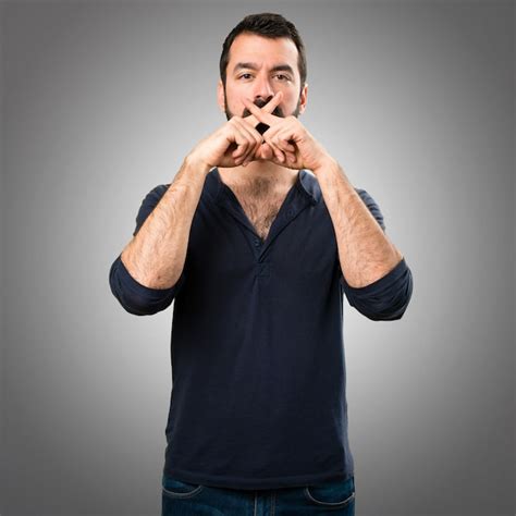 Premium Photo Handsome Man With Beard Making Silence Gesture On Grey