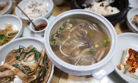 A Korean Mushroom Soup Is Served With Other Korean Dishes Stock Image