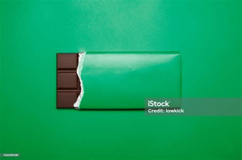 Bar Of Chocolate On Green Background Stock Photo Download Image Now