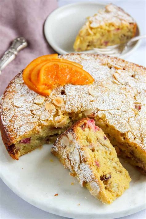 An Orange And Cardamon Rhubarb Cake On A White Plate