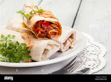 Mexican Burritos Wraps With Mincemeat Beans And Vegetables On A Plate