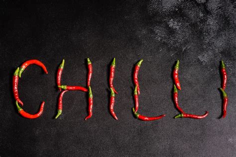 Premium Photo Bright Red Chilli Pepper On A Grey Concrete Background