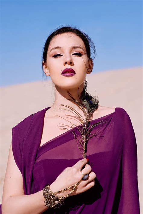 Amazing Beautiful Brunette Woman With The Peacock Feather In Purple