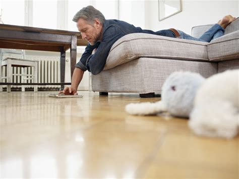 Mature Man Lying On Sofa Using Digital Tablet Stock Photo