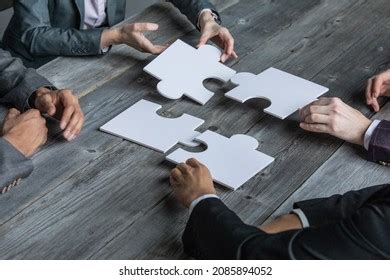 Hands Multiethnic Team Assembling Jigsaw Puzzle Stock Photo