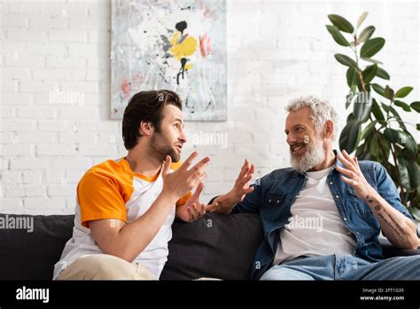 Mature Father And Son Talking In Living Room Stock Photo Alamy
