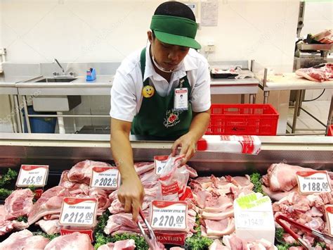 A Butcher At A Meat Section Of A Grocery Store Stock Editorial Photo