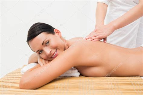 Beautiful Brunette Enjoying A Back Massage Stock Photo Wavebreakmedia