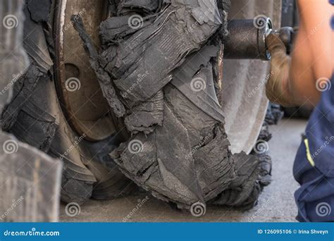 Destroyed Blown Tire With Crushed And Damaged Rubber On A Truck Stock