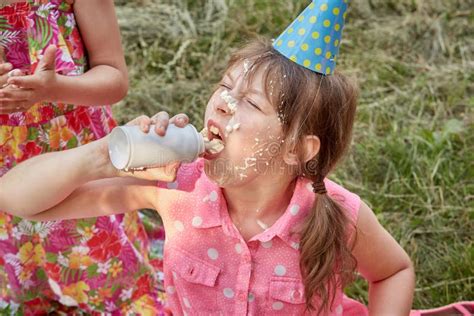 A Girl with a Dirty Face in Eating Whipped Cream. Stock Photo - Image of caucasian, dirty: 202950536