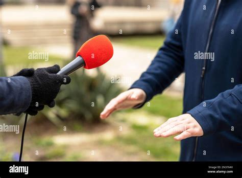 Reporter making media or vox pop interview with unrecognizable male ...