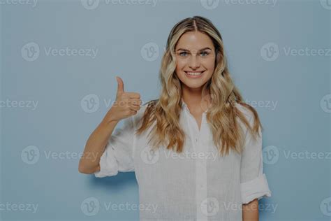 Cheerful Blonde Girl Showing Thumbs Up Gesture 14940262 Stock Photo At